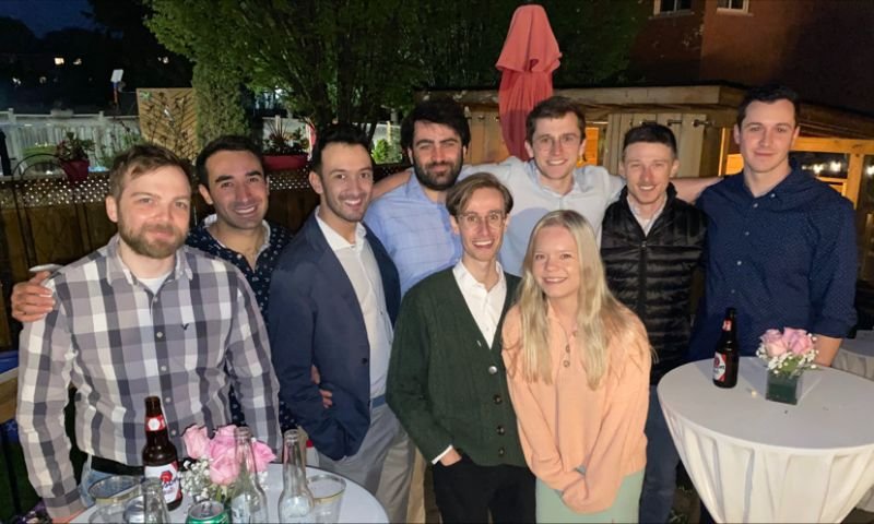 a group of young adults celebrating outside