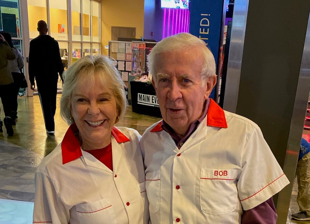Man and Woman standing with matching bowling shirts