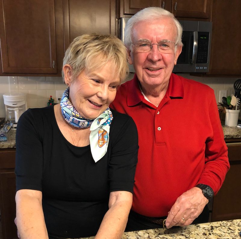 Mom and Dad stand in the kitchen
