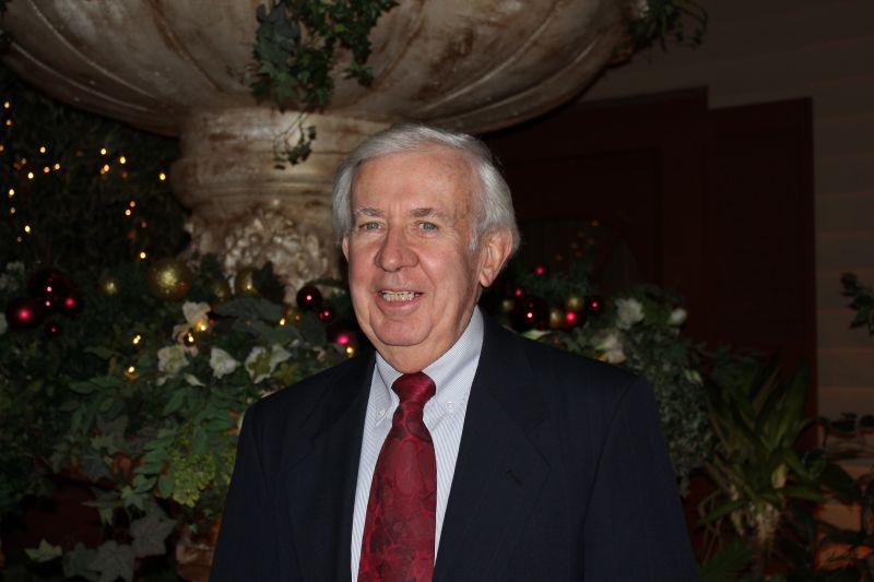 Dad standing in his suit and tie