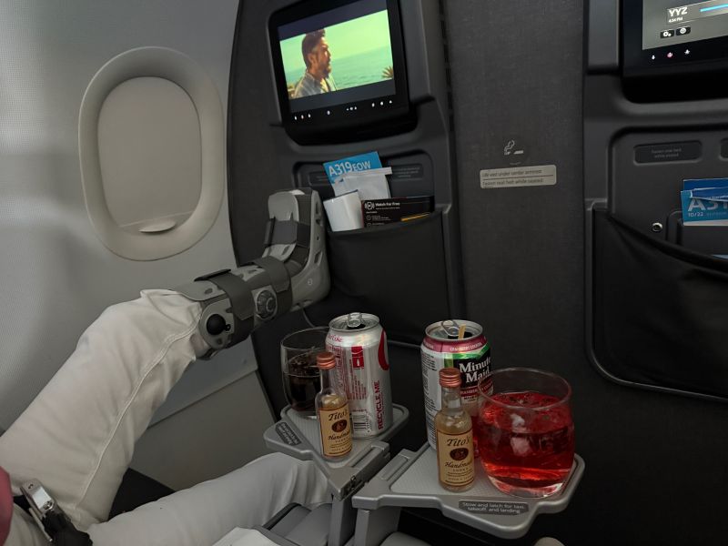 Mom sitting on a plane with a broken foot