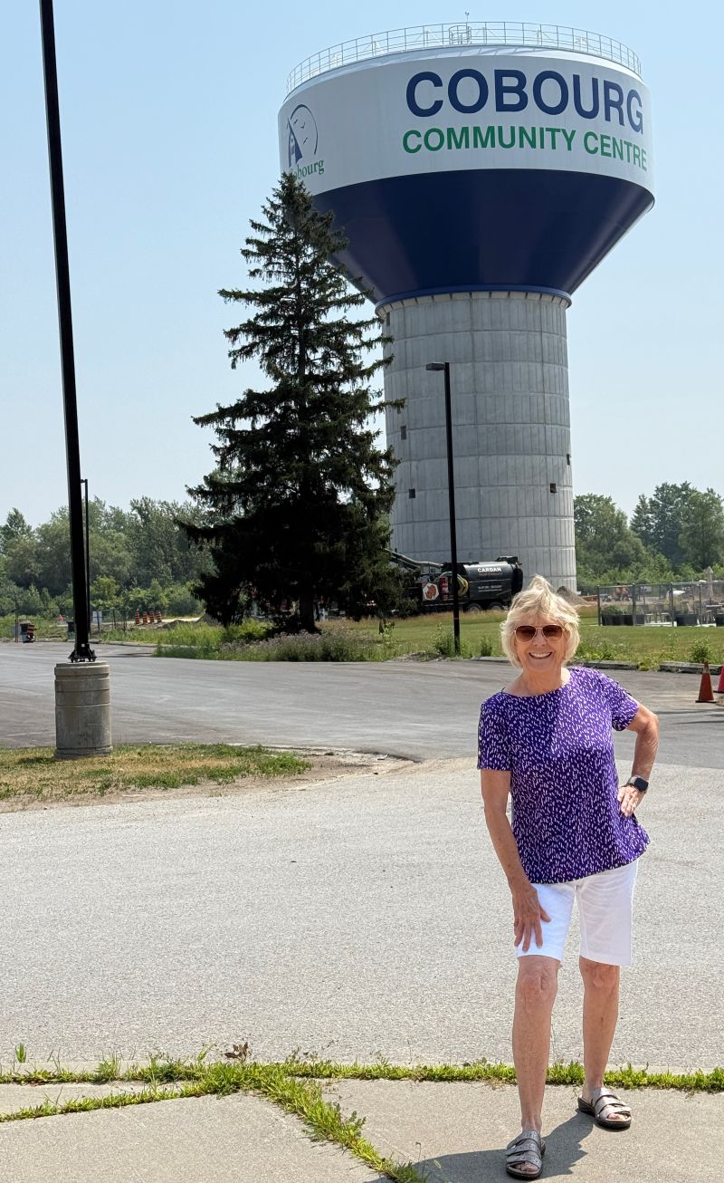 Mom standing by a water tower