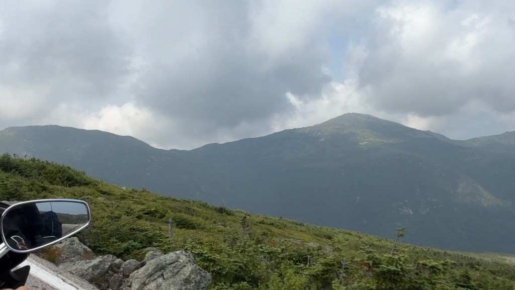 Motorcycle riding through mountains with fog