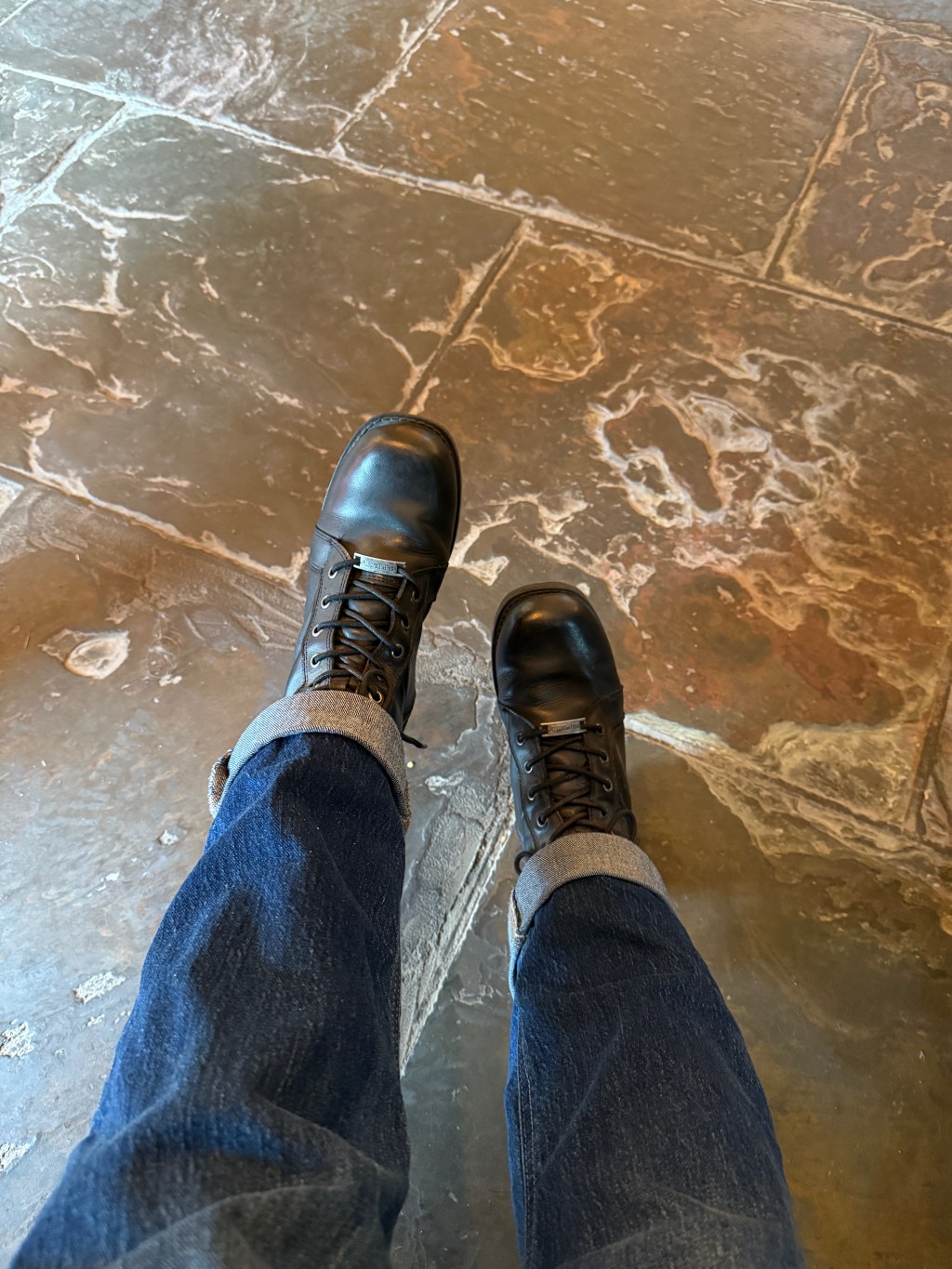 Kelley's legs with her motorcycle boots on