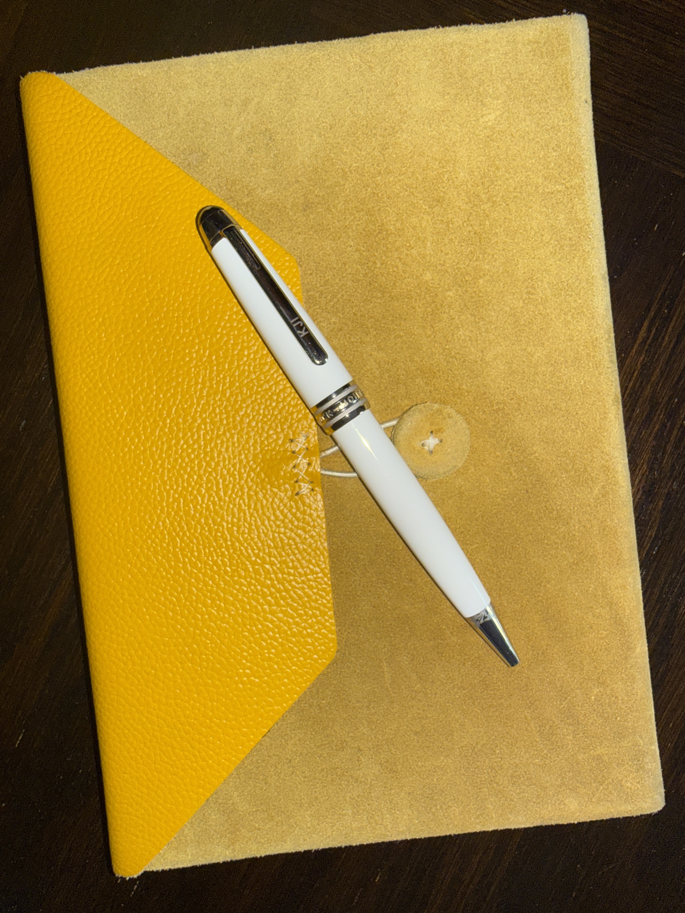 Kelley's yellow book and white Mont Blanc pen for writing books